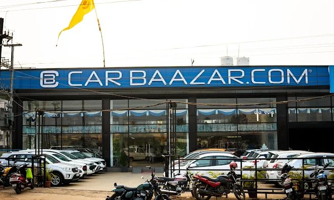 CarBaazar used car showroom on Puri Bypass Road Bhubaneswar with blue signboard and row of cars